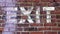 EXIT stenciled on a brick wall