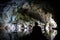 Exiting a dark limestone cave by boat