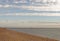 Exmouth, devon: low tide, beach and walkers. Cloudscape horizon