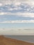 Exmouth, devon: low tide, beach and walkers. Cloudscape horizon