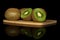 Exotic brown kiwifruit isolated on black glass