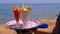 Exotic Cocktails in a Glass with a Straw on a Tray on the Background of the Sea. Egypt.