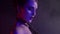 exotic dance performer woman in dark and mysterious studio, closeup of female face and breasts