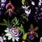 Exotic flowers seamless pattern. Tropical violet bordo orchids, passiflora, wisteria flowers and palm leaves in summer print.