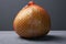 Exotic fruit pomelo on a gray background close-up. pale green citrus