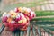 Exotic fruit salad served in half of dragon fruit over palm leaves on rattan background. Copy space. Tropical travel, exotic fruit