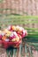 Exotic fruit salad served in half of dragon fruit over palm leaves on rattan background. Copy space. Tropical travel, exotic fruit