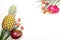 Exotic fruits on a white background, copy space. Pineapple, mango, dragon fruit, lychee. Top view of tropical fruits. Healthy food