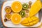 Exotic fruits on white cutting board