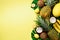 Exotic pineapples, ripe coconuts, banana, melon, lemon, tropical palm and green monstera leaves on yellow background