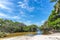 Exotic scenario with palm trees, rivers and white sand in a blue sky day. Exotic destination in north Brazil, South America.