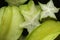 Exotic starfruit.averrhoa carambola in black bowl. Carambola on black background.Healthy food, fresh organic star a