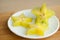 Exotic starfruit or averrhoa carambola on white plate on wooden cut board. Healthy food, fresh organic star apple fruit.