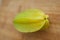 Exotic starfruit or averrhoa carambola on wooden cut board. Healthy food, fresh organic star apple fruit.