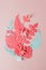 Exotic tropical multicolored leaf paper composition, creative application handcraft on a pink background with copy space. Greeting