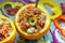 An exotically decorated dish of bulgur, poultry and vegetables with oranges. A portion of colorful stew, top view