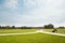 Expanded view of green grass meadow and trees