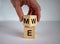 Expanded wood cube with me or we words on beautiful white background, mail hand. Copy space, concept