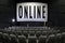 Expanding your business online. Quarantine concept. Watch online background. Cinema with empty seats. Word ONLINE on