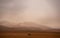 Expansive desert landscape with a vehicle driving on the road