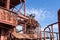 Expansive industrial steel manufacturing facility, rusted beams and girders, vivid blue sky