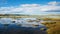 Expansive Landscapes: A River With Rocks In The Water