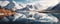 expansive panoramic shot of a tranquil lake surrounded by majestic mountains, with the reflection of the snow-capped panorama