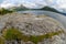 Expansive View of a the sea and Majestic Mountains Under a Cloudy Sky