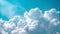 Expansive view of soft, fluffy cumulus clouds against a bright blue sky, serene and peaceful