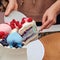 The expectant mother cuts a piece of cake to determine the gender of the child at the party, boy or girl