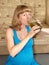 The expectant mother drinks a cucumber brine, sitting on a floor