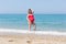 Expectant mother resting on sand beach in early time