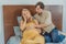 Expectant woman feels unwell, husband comforts and reassures her during a challenging pregnancy
