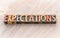 Expectations word abstract in wood type