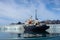 Expedition vessel in Arctic sea with glacier on background