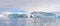 Expedition vessel in front of Antarctic iceberg landscape at Portal Point