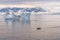 Expeditions - Zodiac with tourists cruises through Antarctic iceberg landscape at Portal Point