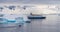 Expeditions - Zodiac with tourists cruises through Antarctic iceberg landscape at Portal Point