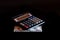 Expenses cost, budget and tax or investment calculation, one hundred dollar with calculator on dark black background table