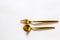 expensive cutlery made of gold, fork and spoon on a white background, place for text