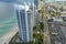 Expensive highrise hotels and condos on Atlantic ocean shore in Sunny Isles Beach city and busy street traffic. American