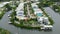 Expensive waterfront houses between green palm trees in southwest Florida. Premium housing development in the USA