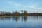 Experience Autumnal Serenity by a London Lake, with Orange Buoy and Trees.