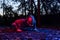 Experienced athlete wearing a high altitude simulation mask doing push-ups in the park at dusk, functional workout