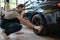 Experienced car detailer buffing the automobile tire