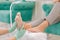 Experienced chiropodist making feet massage for woman