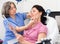 Experienced cosmetology doctor examines a young woman patient before the procedure