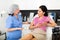 Experienced cosmetology doctor tells a young female patient about the health of the female breast