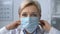 Experienced doctor putting on protective mask, viral disease risk, patient POV