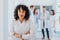 Experienced Female Doctor Posing with Confidence, Looking at Camera, in Group Portrait of Happy Hospital Workers